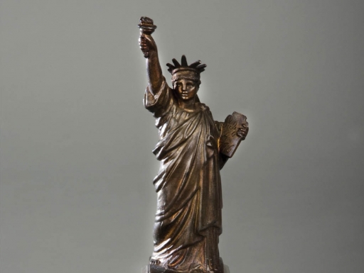 Image: Photograph of a model of the Statue of Liberty. Text: Grades 3–5