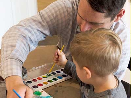 parent painting with a child.