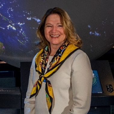 Elle Stofan poses in front of moon exhibition at the Air and Space Museum