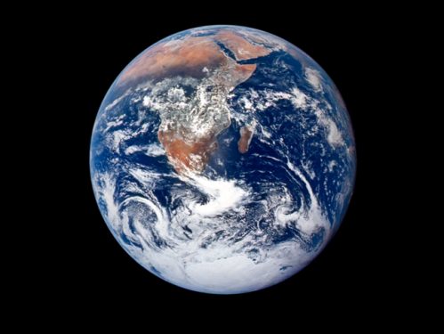 Satellite image of blue and green Earth covered with white clouds and a black background. 